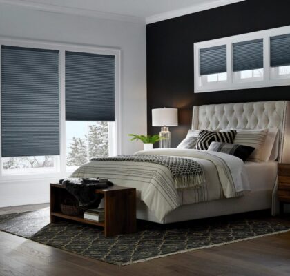 Modern bedroom with tufted bed and large window.
