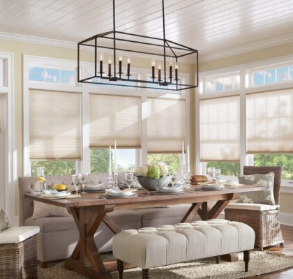 Bright dining room with rustic wooden table and cushioned bench seating.