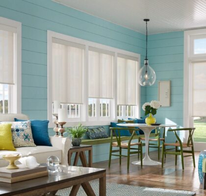 Bright, airy dining and living area with blue walls and modern furniture.