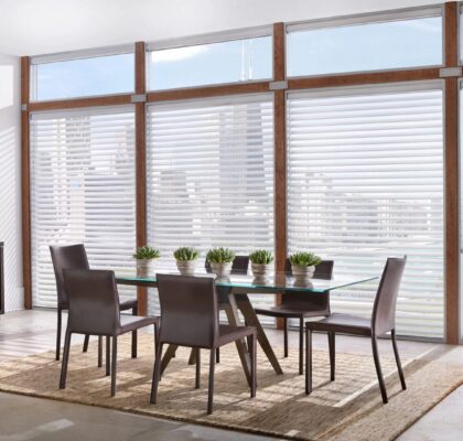 Modern dining room with glass table and city view.