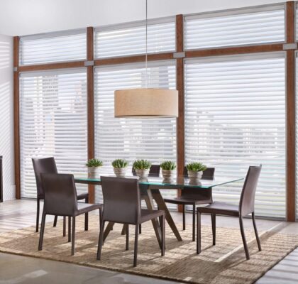 Modern dining room with wooden table and chairs, large windows, and stylish pendant light.