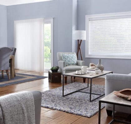 A modern living room with light blue walls and cozy furniture.