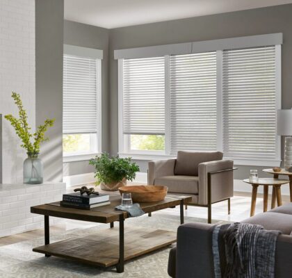 Cozy gray armchair beside wooden coffee table