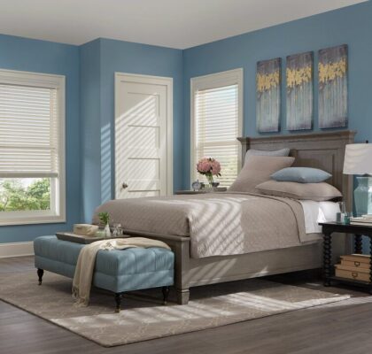 Cozy bedroom with blue walls and modern decor.